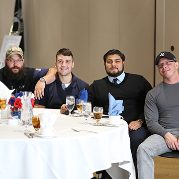 Four JCCC veteran employees at a table