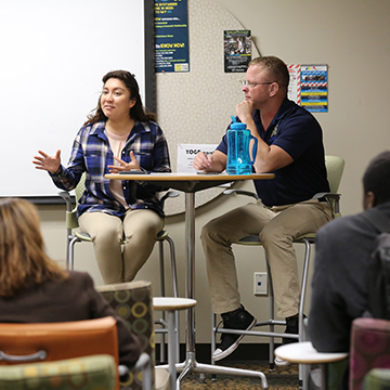 Two veteran students at a table during the Ask A Vet event