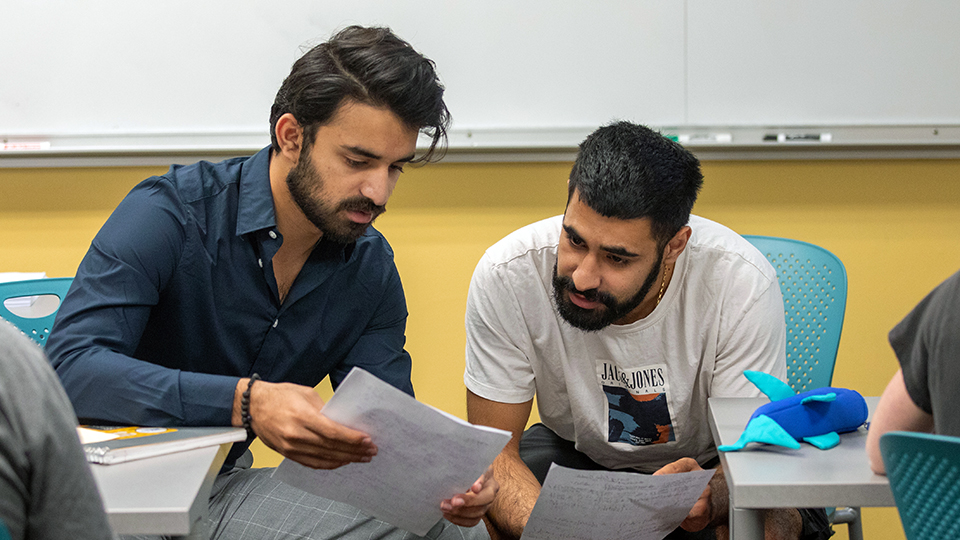 Two students working through a math problem.