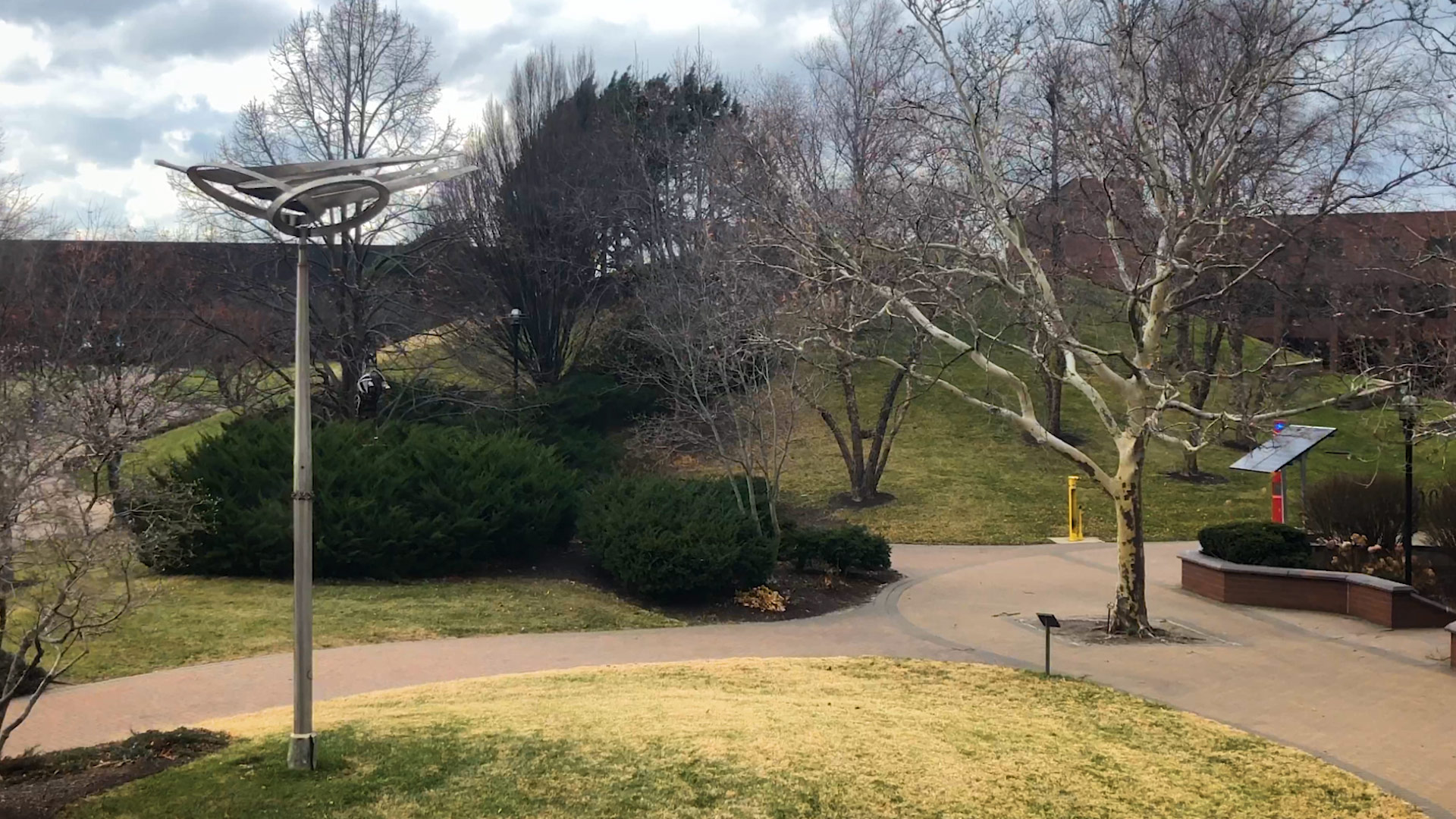 Outdoors view by the Commons Building, Indoor view of stairs at the Student Center, the NARS railroad car lit with festive lights.