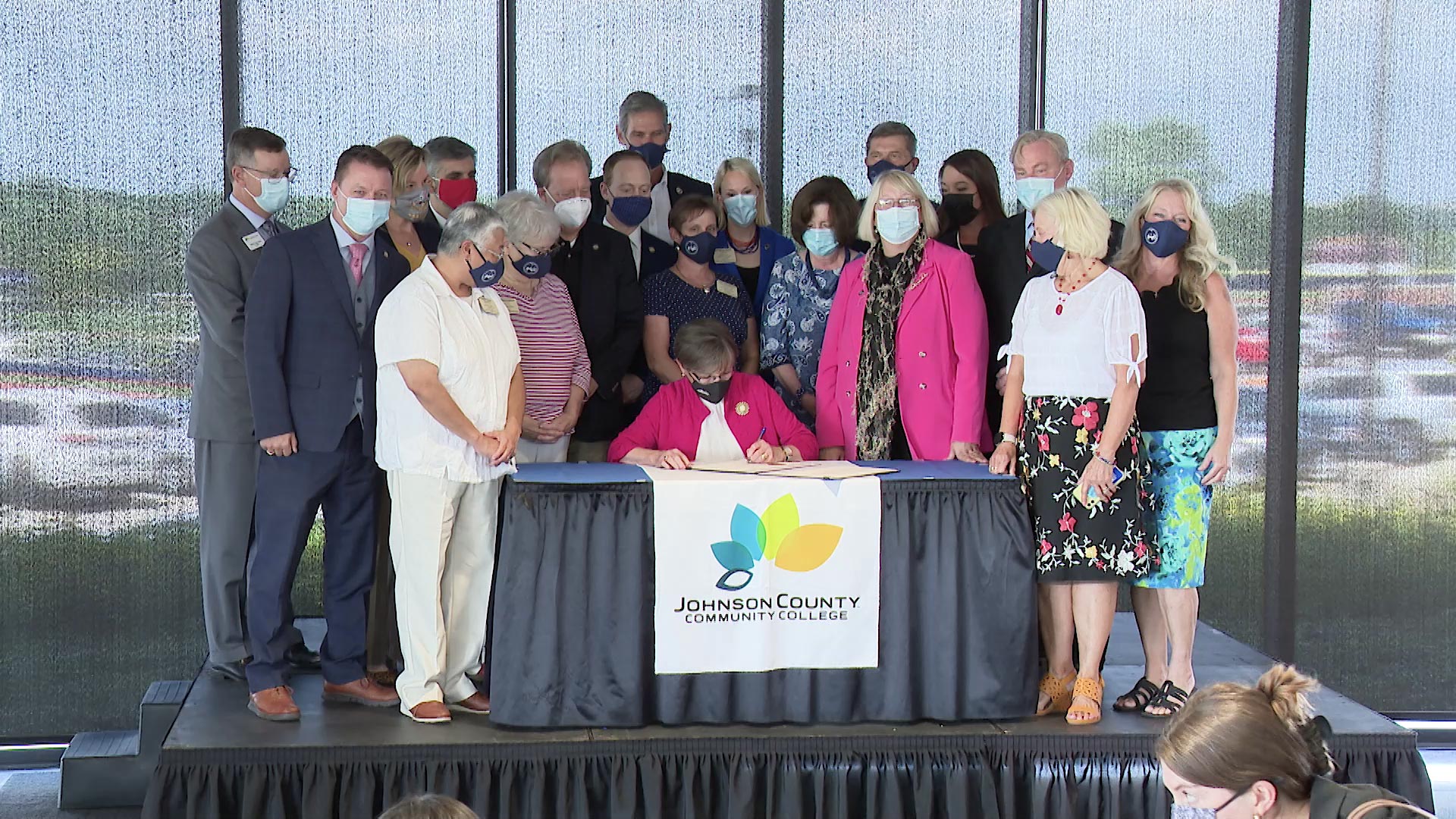 The governor of Kansas and various lawmakers at the signing of the Kansas Promise Act