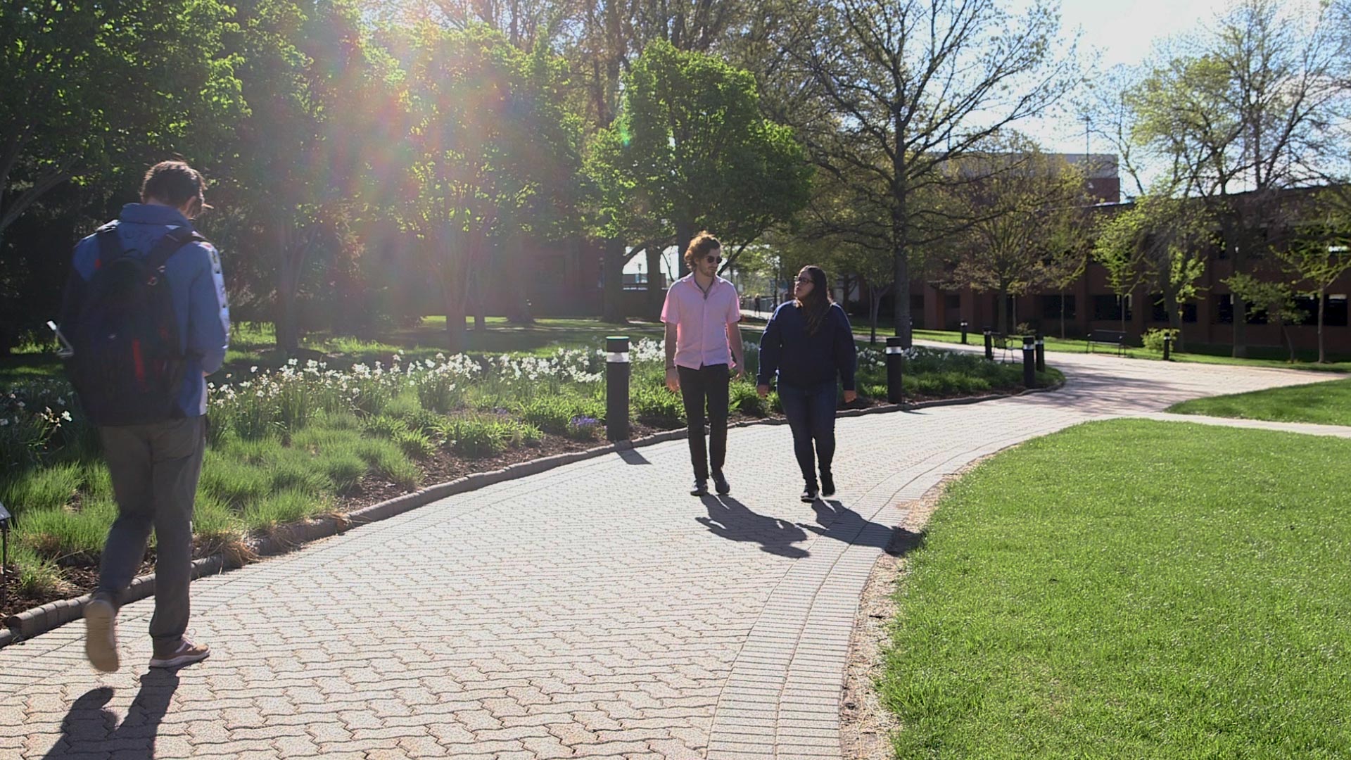 Students walking on a path between the science building and Galileo's Pavilion