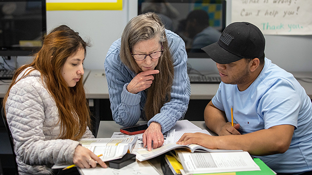 Students studying with a tutor in one of JCCC's resource centers