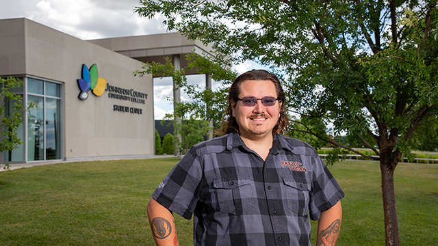 Logan Grigsby stands in front of the Student Center