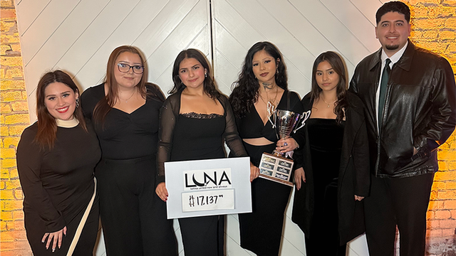 Members of the LUNA club holding a trophy