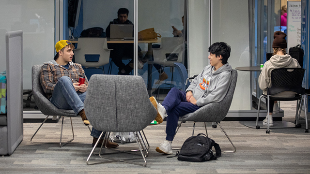 Students chatting in a study space lounge.